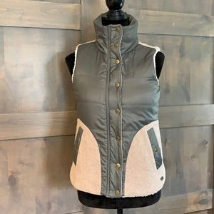 Carve design, olive, tan, and ivory vest.